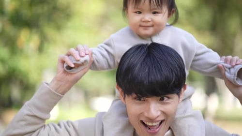Happy Father and Baby Daughter in Park