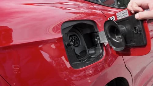 Connecting to a high-voltage charger to recharge an electric car. The future of the automotive indus