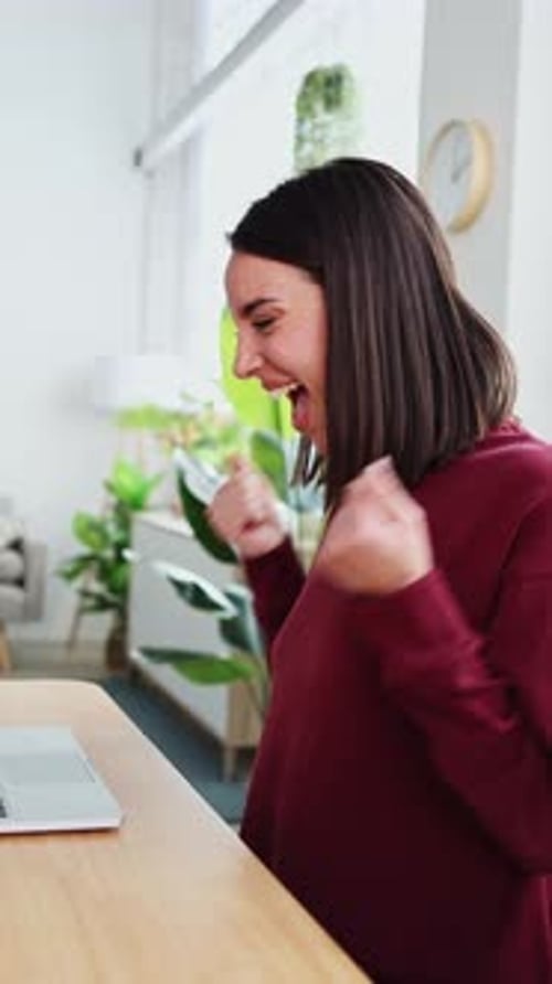Excited Young Professional Woman Celebrating Success While Working From Home Office