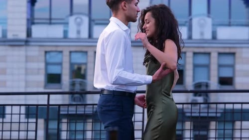 Affectionate Couple Embrace on Urban Balcony