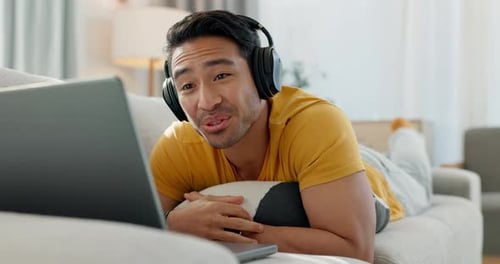 Smiling Man Video Chatting on Laptop at Home