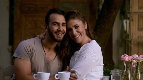 Dating couple enjoying coffee and conversation in a trendy urban cafe