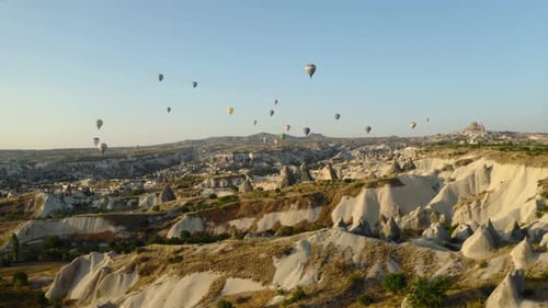 Hot air balloons soar over Cappadocias stunning landscape at sunrise