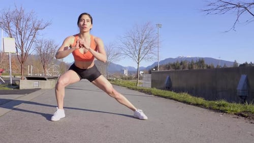 Fit Woman Does Lateral Lunge Exercise Outdoors