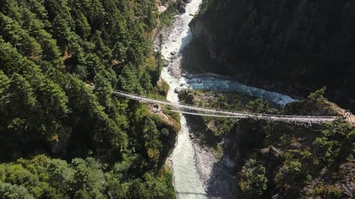 Aerial View of Twin Suspension Bridges Spanning a Nepalese Gorge
