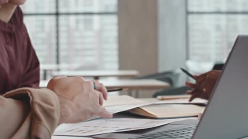 Business Team Analyzing Documents during Cafe Meeting