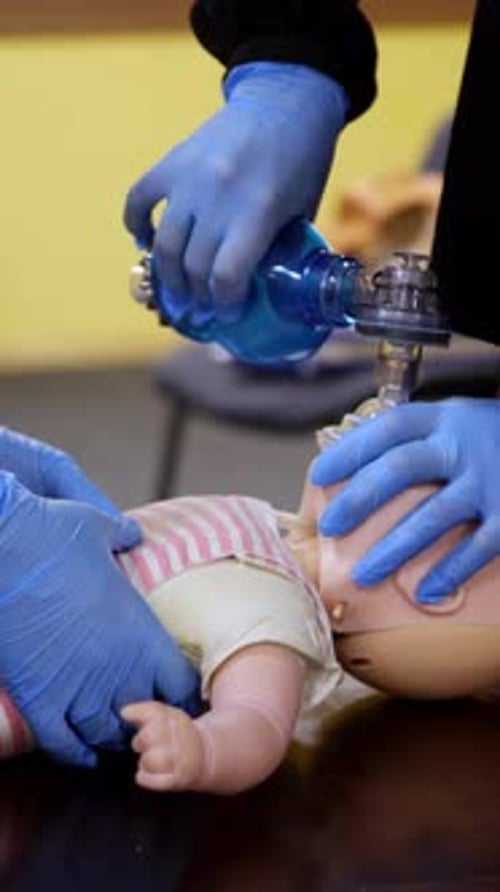 Medical Professional Demonstrates Infant CPR Technique