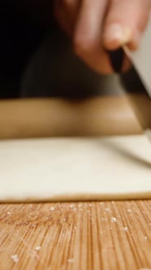 I cut the puff pastry into two halves to roll it out with a wooden rolling pin. Vertical video Socia