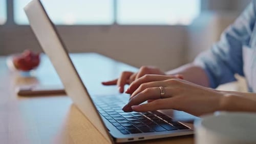 Woman Typing on Laptop Keyboard Close Up