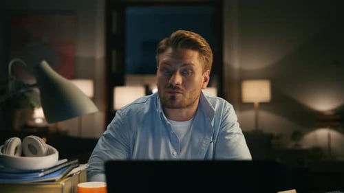 Man Working Late at Night Using Laptop