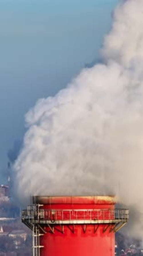 Industrial Chimney Emitting Smoke in Urban Environment