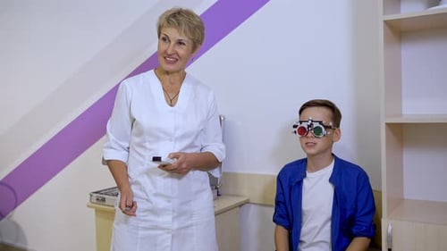 Portrait of a kid boy wearing corrective glasses with replaceable lenses. Ophthalmology clinic.