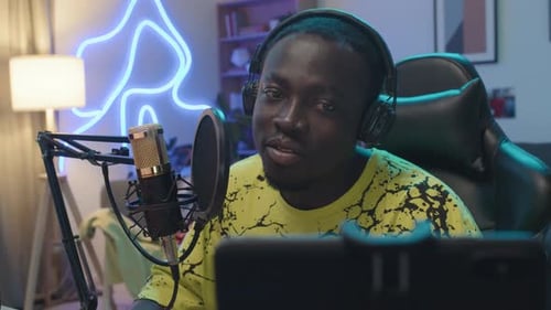 Person Speaking into Microphone in Home Studio