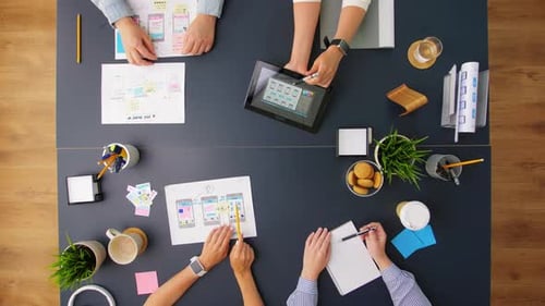 Design Team Collaborating on App Interface on Table