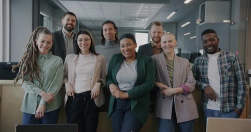 Portrait of Cheerful Men and Women Colleagues Standing in Shared Office Smiling Looking at Camera