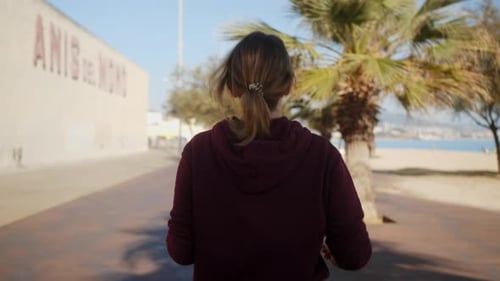 Back View of Athletic Female Running on Seashore Fitness Woman Practicing Cardio Training on Beach