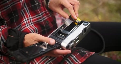 Woman Loading Film into Vintage Leica Camera
