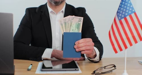 Man holds Passport with US Dollars and American Flag