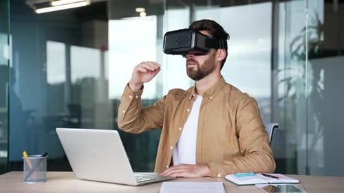 Successful businessman works using VR glasses in virtual reality simulator sitting at workplace