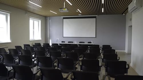 Chair Rows and Projection Screen in Conference Hall