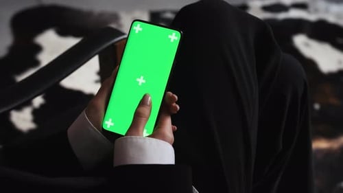 Business Woman Using Smartphone Viewing Green Screen on Mobile Phone Browsing Chroma Key Online