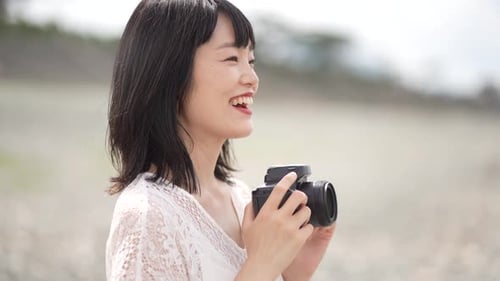 Woman Smiling and Taking Pictures Outdoors