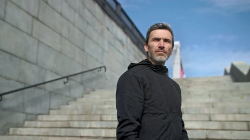 Portrait of Focused European Runner at Cold Weather Young Sportsman Wearing Hat and Hooded Zipper