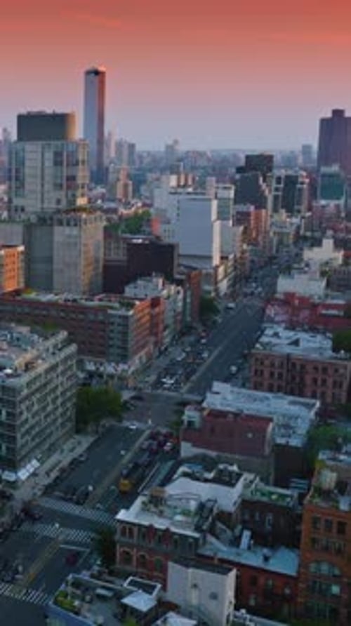 Diverse architecture of beautiful New York. Broad street with cars moving along.