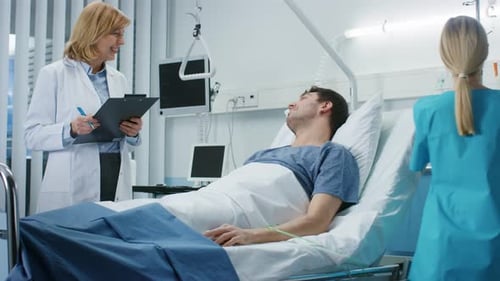 Man in hospital bed being attended by doctor