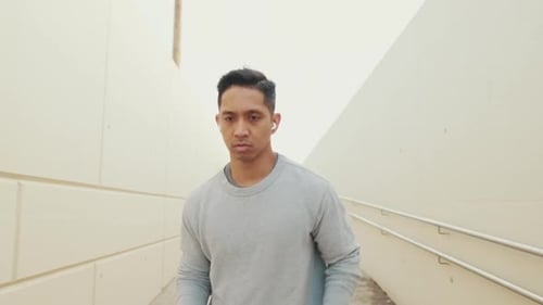 Young man in wireless headphones on a morning run