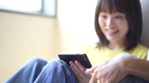 Happy Couple Looks at a Smartphone Together