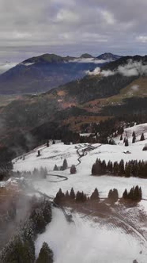 Snowy mountain landscape alpine Switzerland aerial drone rural rolling hills