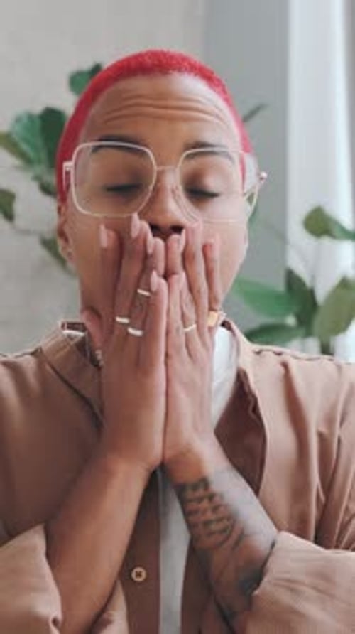 Shocked Young Adult Covers Mouth with Hands