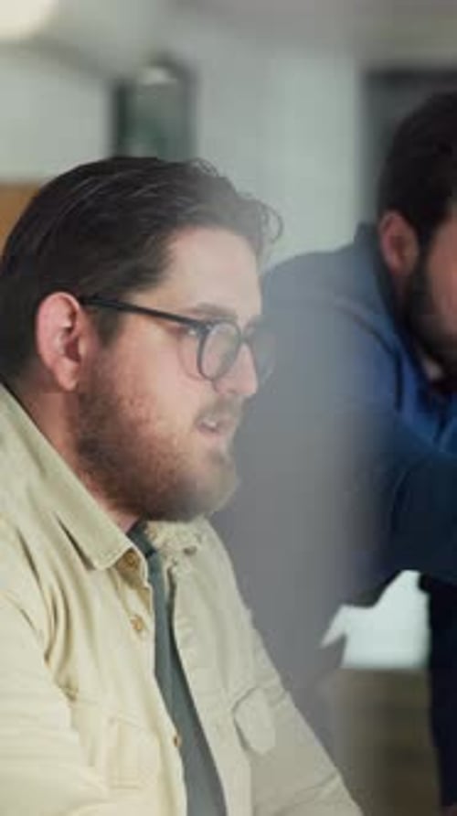 Men, laptop and discussion in office for planning, feedback or project management