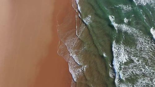 Tropical beach aerial view, Top view of waves break on tropical yellow sand beach. Sea waves seamles
