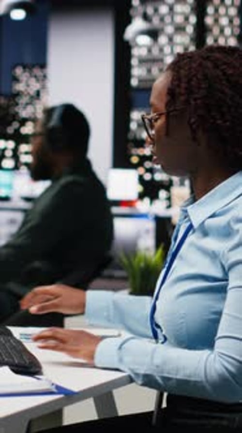 Vertical Video African American Woman Reviewing KPI Metrics with Artificial Intelligence