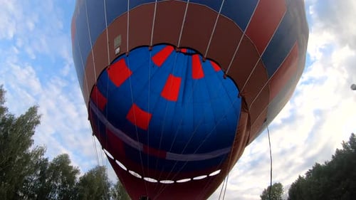 Colorful Hot Air Balloon Inflation with Flames Outdoors
