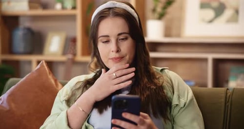 Woman Using Mobile Phone While Relaxing on Couch