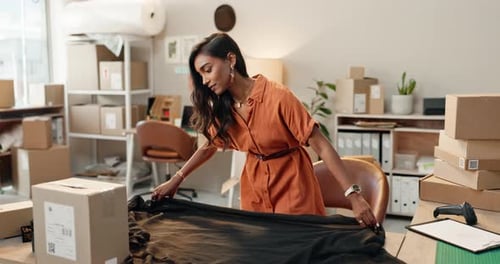 Fashion, design and ecommerce, woman with fabric and boxes for small business in office