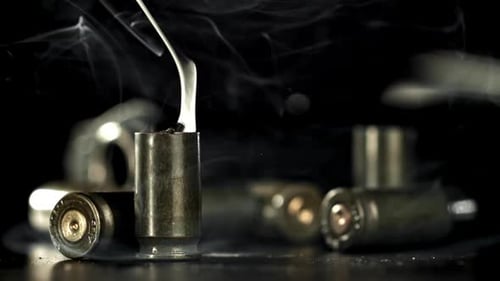 Smoking Bullet Casings on a Dark Background