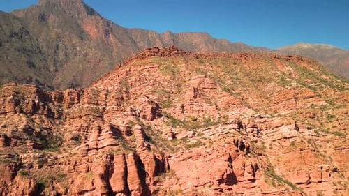 Luftbilddrohne, die über malerische rote Rocky Mountains mit klarem blauem Himmel fliegt.