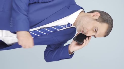 Businessman in Suit Talking on Mobile Phone