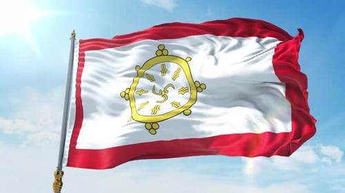 Waving Flag with Buddhist Dharmachakra Symbol against Blue Sky