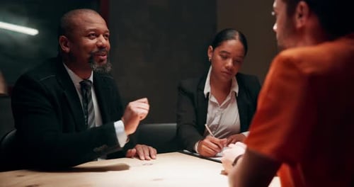 Lawyer, conversation and criminal client in interrogation room for investigation