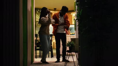 Playful Couple Dancing Together in Apartment Living Room