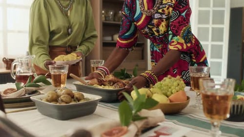 Women Serve Food at Dinner Table in Home