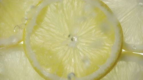 Lemon Slices Underwater with Rising Bubbles