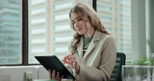 Young Adult Woman Using Tablet in Office