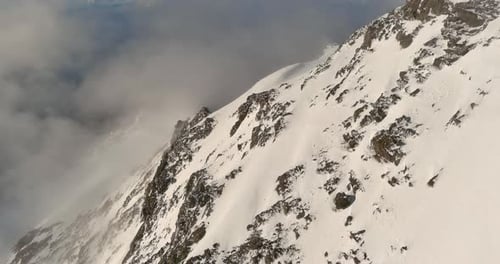 Snowy Mountain Peak Above Clouds. British Columbia, Canada.