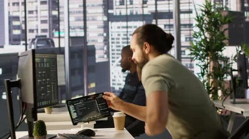 System Administrator Checking Machine Learning Results on Tablet